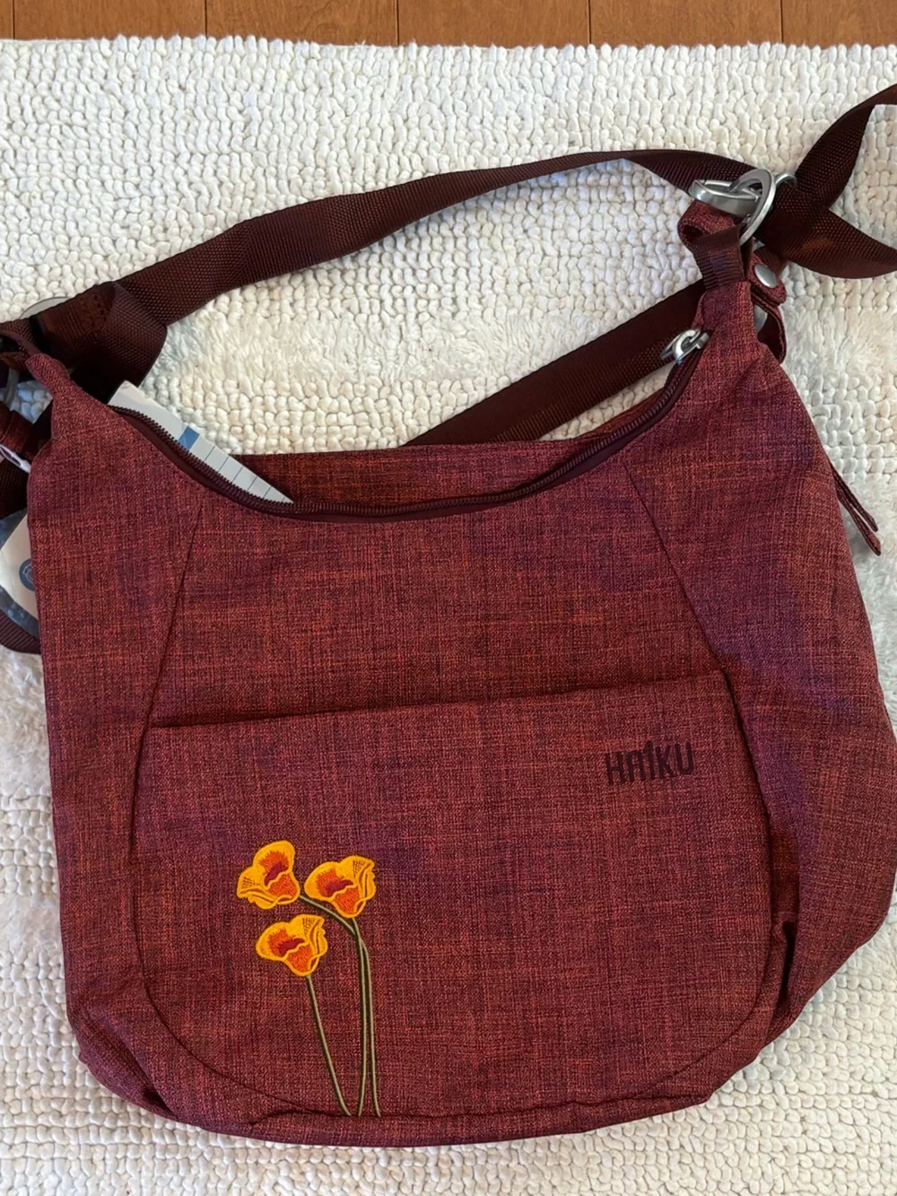 Haiku Amble Hobo Bag in Rust Red with Yellow Floral Detail
